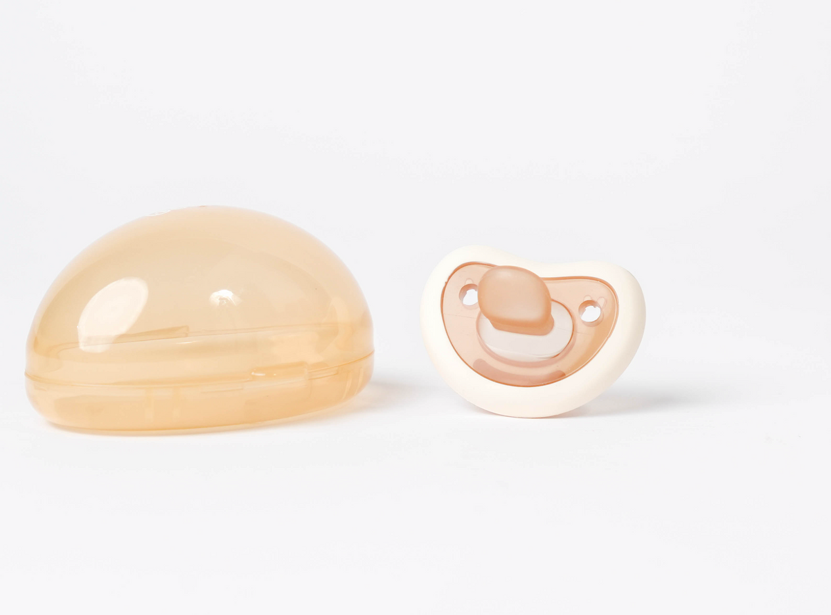 Creamy white Bebina Happy Face pacifier with a smiling face design for babies, made of soft, safe materials.